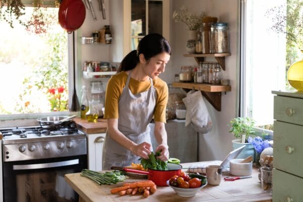 Asian woman busy cooking in the kitchen