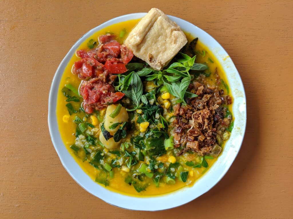 Top view of traditional bubur manado tinutuan manadonese porridge in a bowl jajandikitid kuliner khas manado Top view of traditional Bubur Manado Tinutuan Manadonese porridge in a bowl
